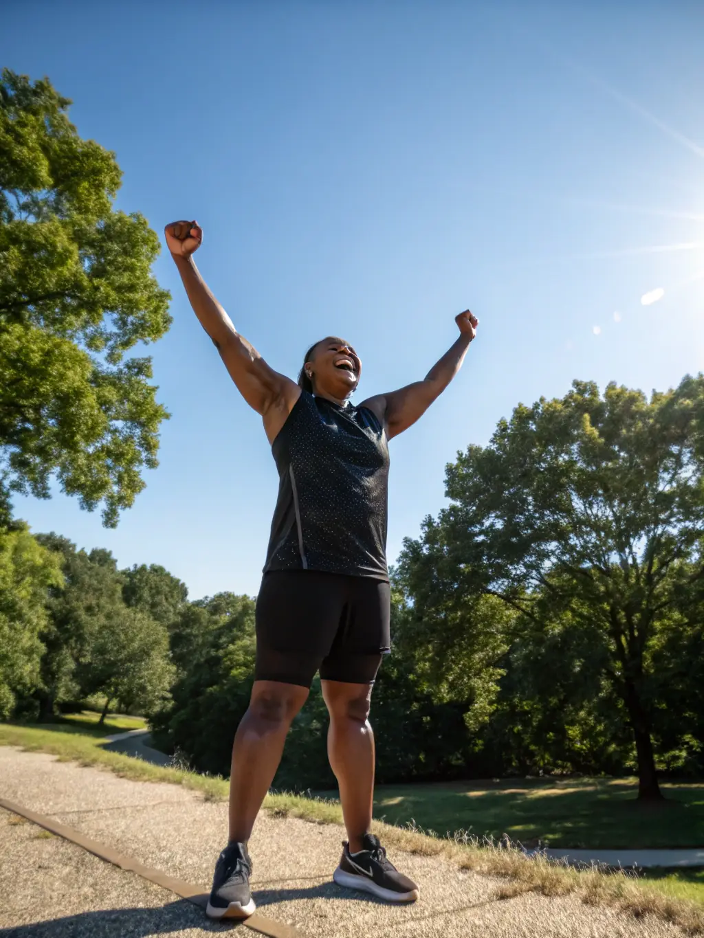 A person celebrating with arms raised, symbolizing the achievement of goals and successful transformation.